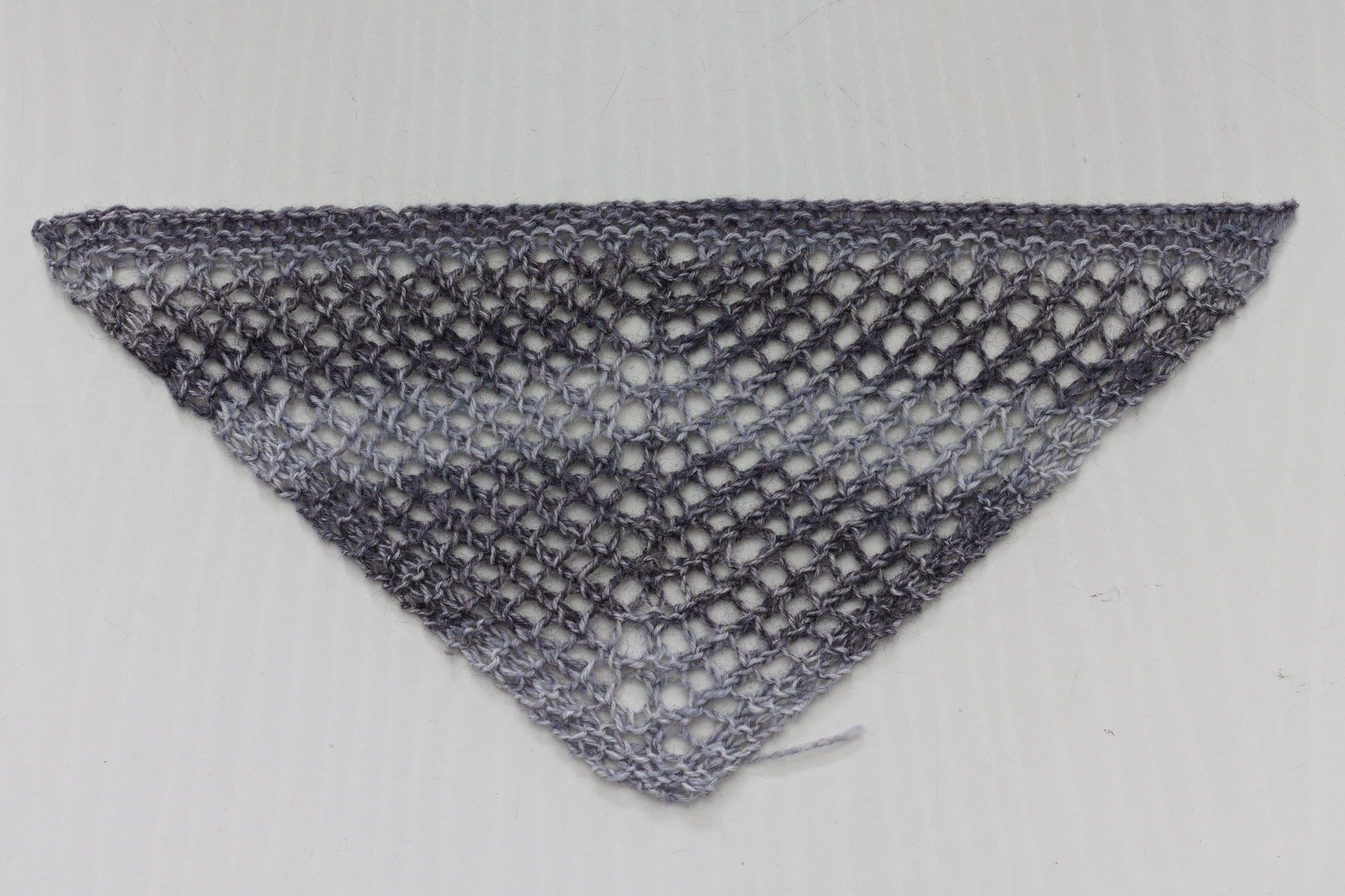 A mini-shawl in self-striping gray yarn.